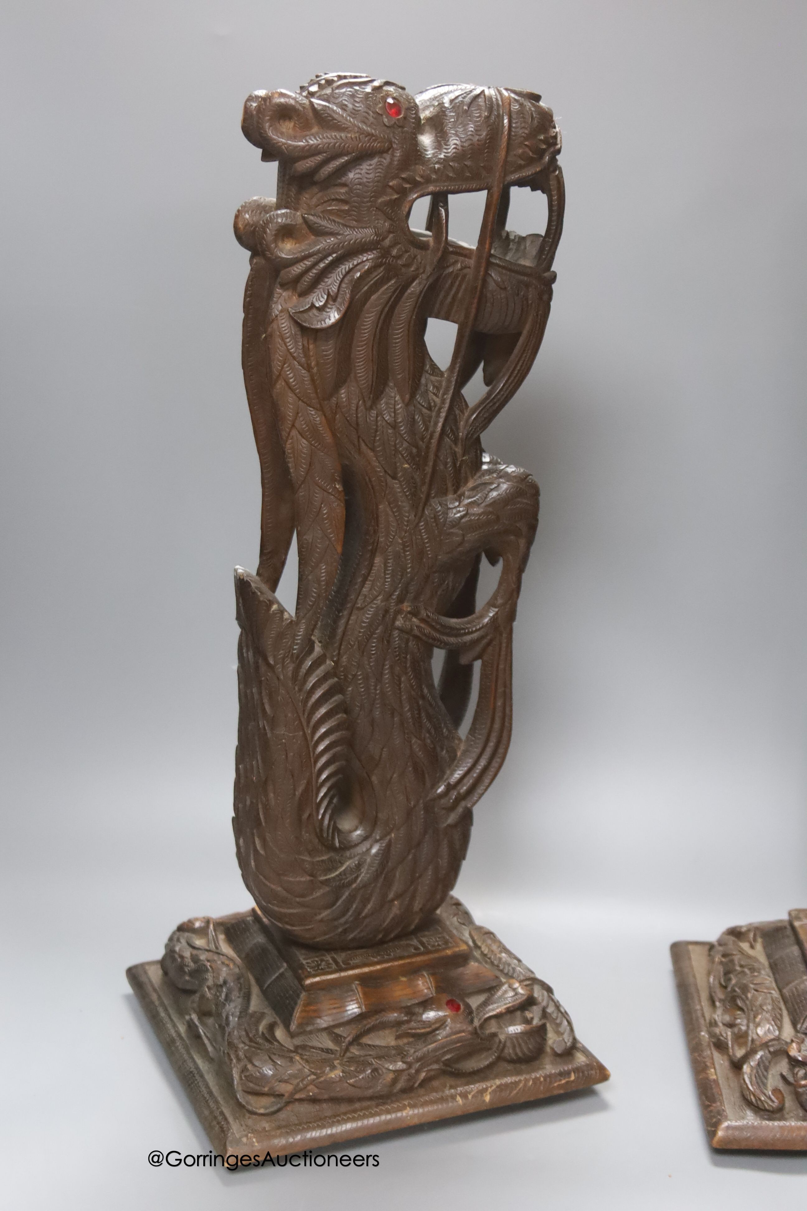 A pair of Burmese carved hardwood 'dragon' lamps, height 50cm, lacking light fittings